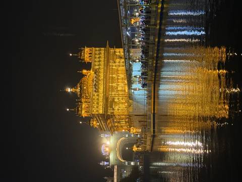 Golden temple at night reflecting on water