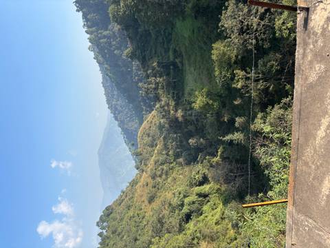 View of a lush green valley with mountains in the distance