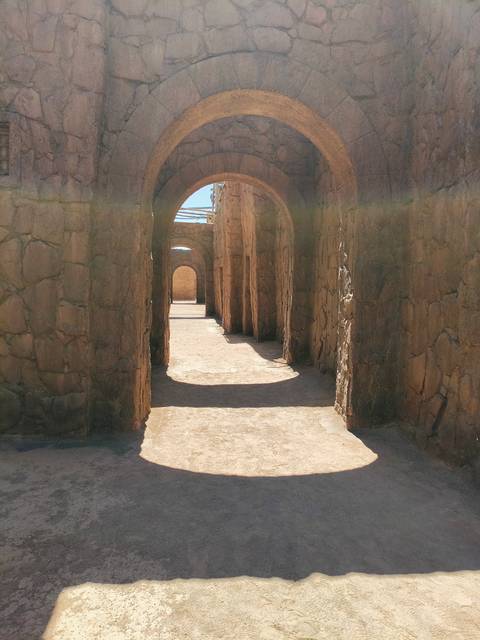 Deserted narrow passageway with stone walls.