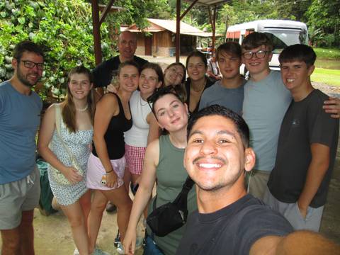 Group of friends posing together outdoors.