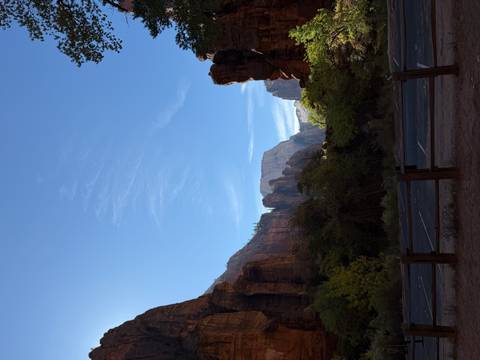 Scenic view of a canyon with towering cliffs against a clear blue sky.