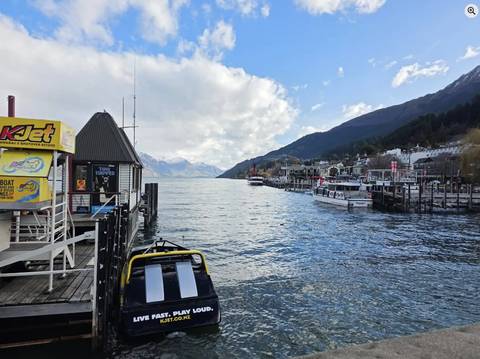       Harbor with boats and mountains in the distance.
  