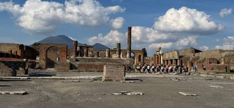       Ruins of Pompeii with Mount Vesuvius in the background.
  