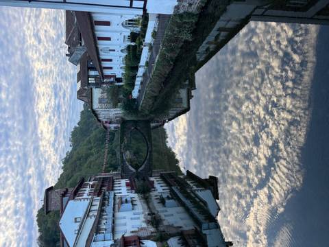 Reflections of buildings and bridge on a river.