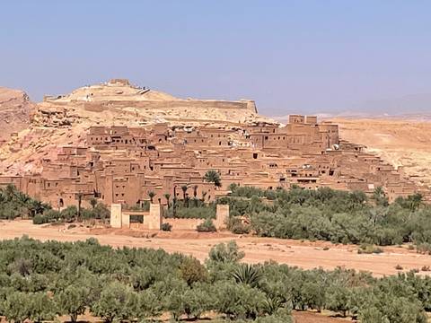       Ancient city on a hill with surrounding greenery.
  