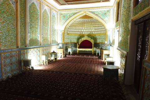 Lavishly decorated interior with a throne-like chair.