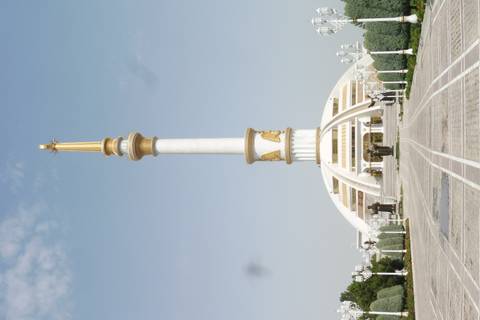Tall white and gold monument with statues.