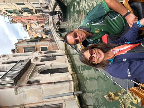 Couple in a gondola on a canal in Venice.