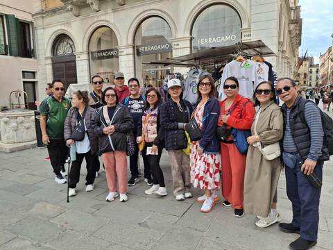 Group of people on a city street near luxury stores.