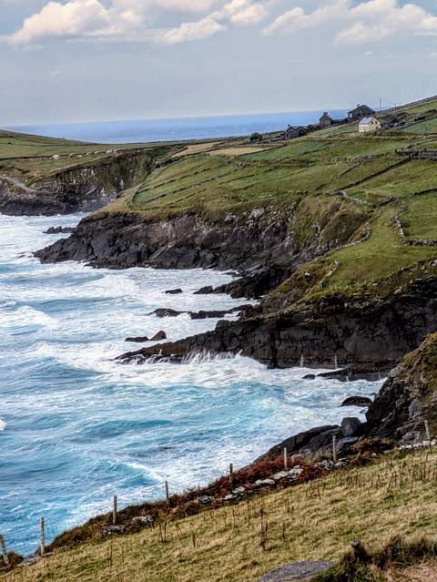       Rugged coastline with waves crashing against rocky cliffs.
  