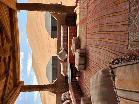       Cozy outdoor seating area with view of sandy dunes.
  