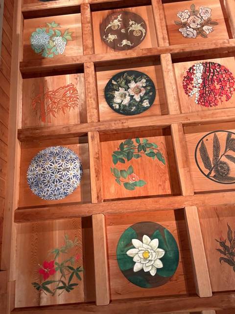 Wooden artwork of floral designs and patterns.