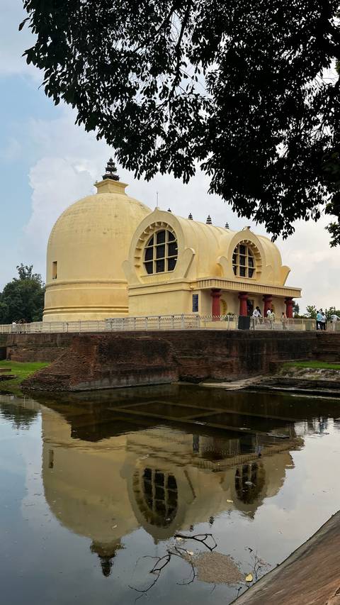 Golden domed building against a partly cloudy sky.