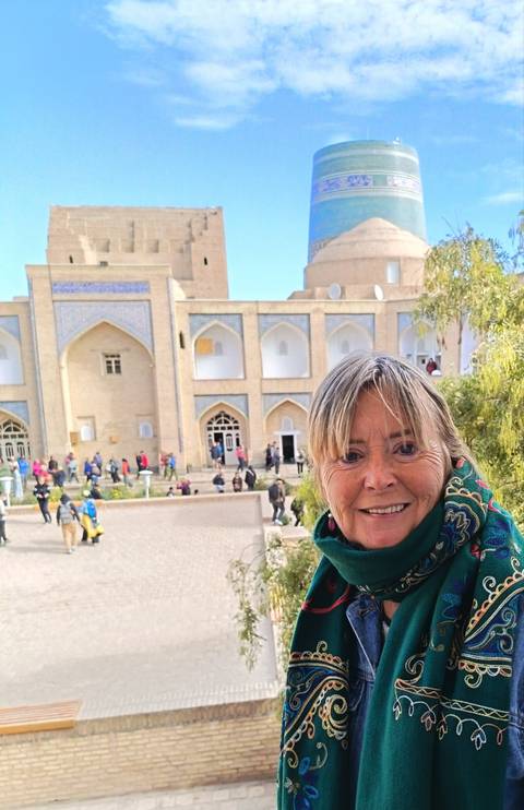       Woman taking a selfie with a historic building in the background.
  