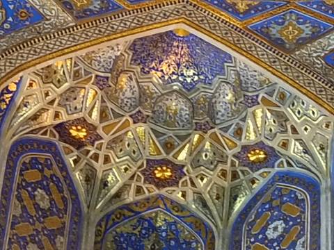       Intricate mosaic ceiling with blue and gold patterns.
  