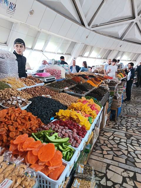       Market stall displaying an array of dried fruits and spices.
  
