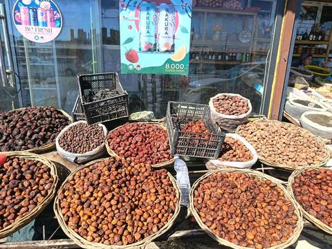      Display of various dried fruits at a market.
  