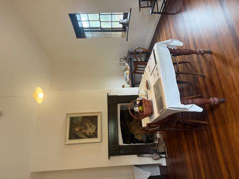       Interior of a room with a dining table set.
  