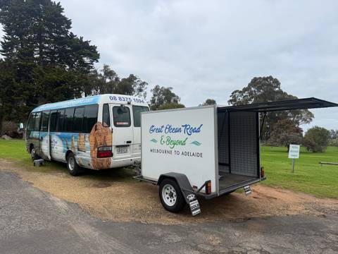       Tour bus parked on a rural roadside.
  