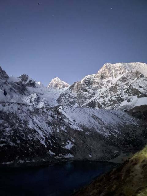 Expansive snowy mountain range under a clear sky.