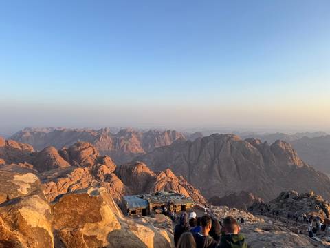 Mountainous landscape with a clear sky at sunrise.