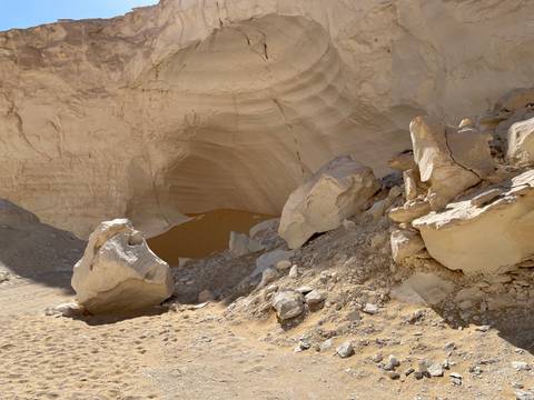      Boulders and rocks in a desert cave.
  
