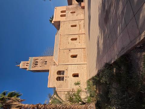 Old brick tower against a clear blue sky.