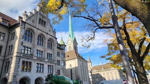 Scenic view of a church with a spire, surrounded by trees with autumn foliage.