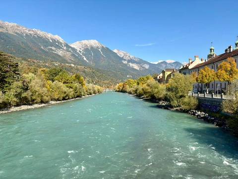 River with surrounding mountains and autumn trees.