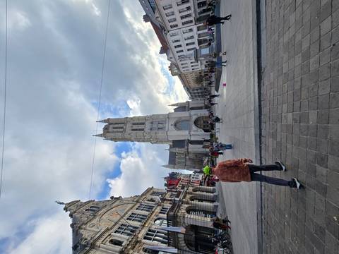 Cathedral with central square and people walking.