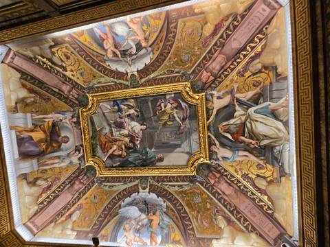 Elaborately painted ceiling with classical art.
