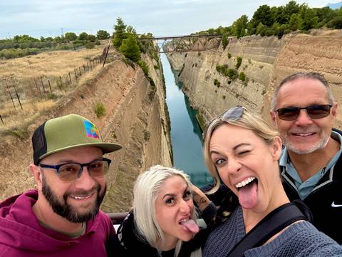       Group of friends posing by a canal.
  