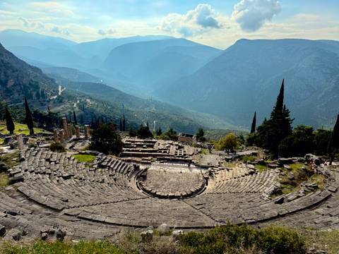       Ancient amphitheater with a mountain view.
  