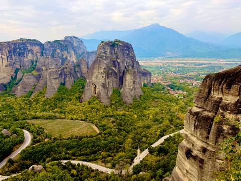       Rock formations with greenery in a mountainous area.
  