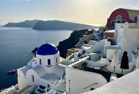Santorini view with white buildings and a scenic coast.