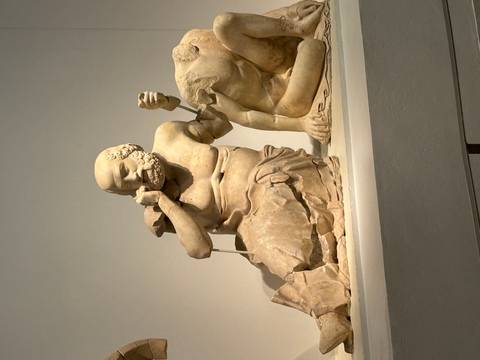 Classical marble statue displayed in a museum.