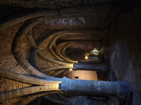       Gothic-style archways inside an ancient stone structure.
  