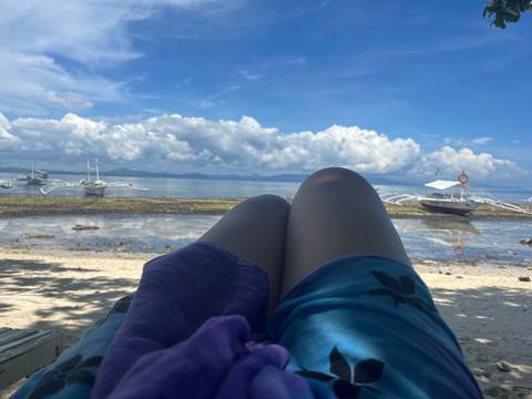View from the beach with boats and clear sky.