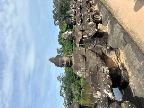 Row of stone statues with serene expressions in a historical setting