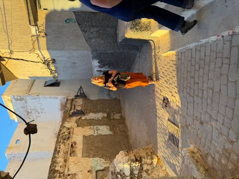 Woman walking down a narrow street