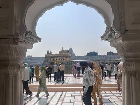 Golden Temple in Amritsar viewed through a decorated arch.