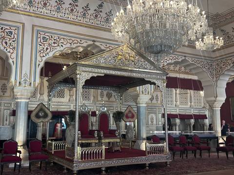Opulent interior of a palace with chandeliers in Jaipur.
