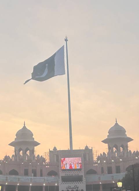       A flag waving against a hazy sky.
  