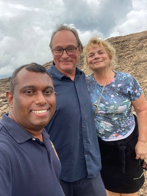 Close-up selfie of three people outdoors.