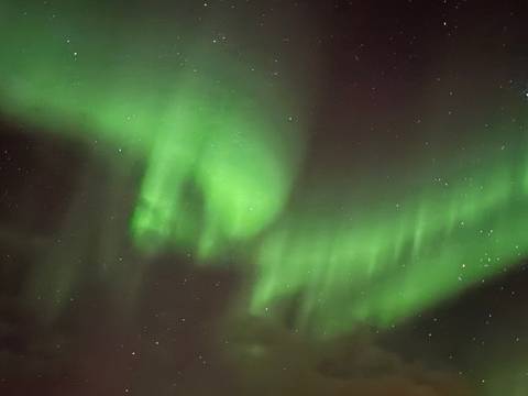 Blurry northern lights in the night sky.