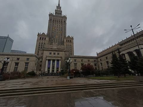 Palace of Culture and Science in Warsaw under a cloudy sky.