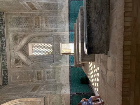 Interior of a historical building with decorative stone benches.