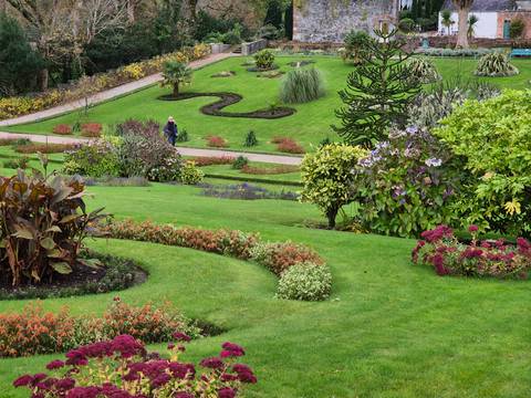 Beautifully manicured garden with various plants and pathways.