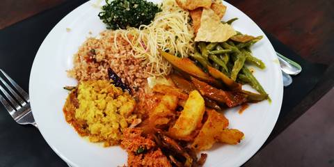 Plate of assorted Sri Lankan dishes.
