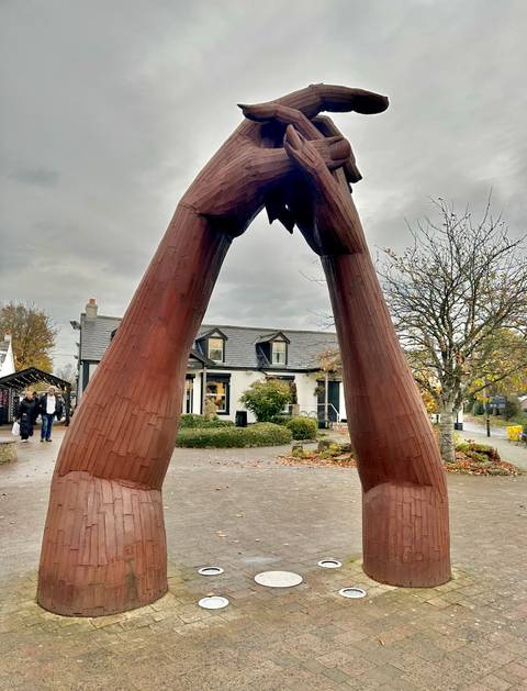 A sculpture made of wood situated outdoors.